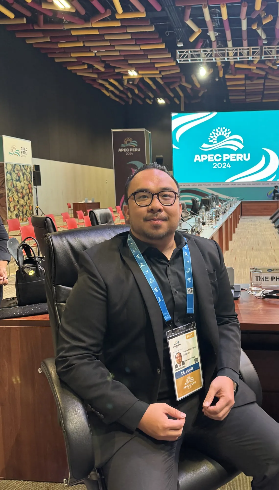 Rainier Milanes seated at a conference table during an APEC digital-economy meeting.