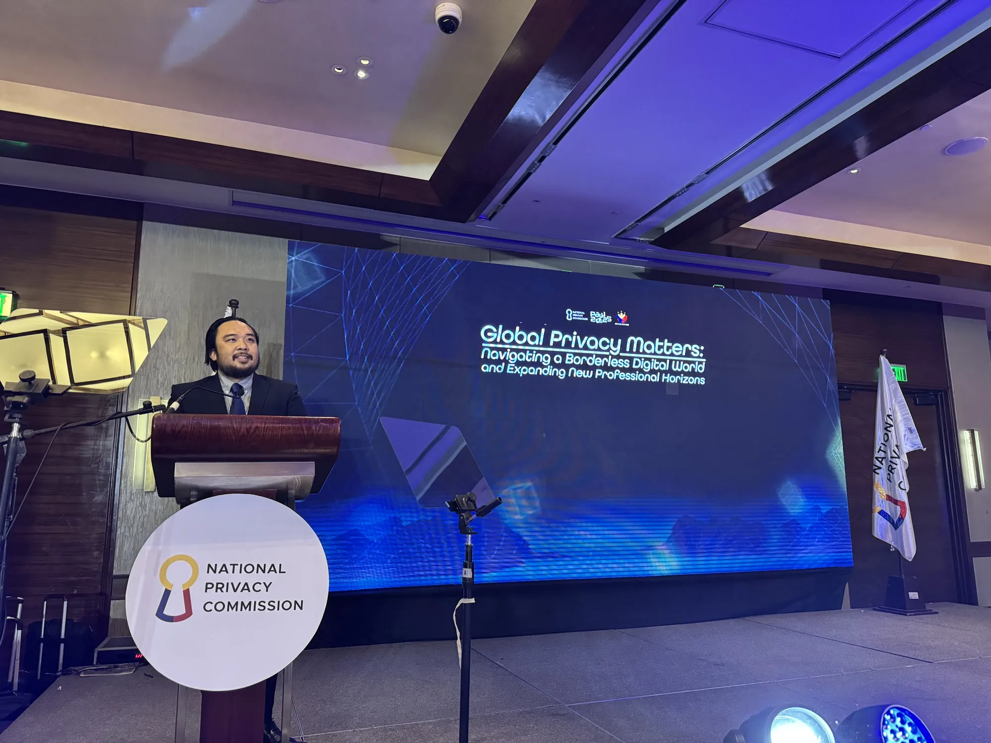 Rainier Milanes speaking at a lectern during a global privacy session.
